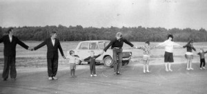 Image of adults and children holding hands
