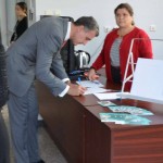 Romanian prince bends over to sign his consent form