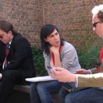 Two people discuss plans outside